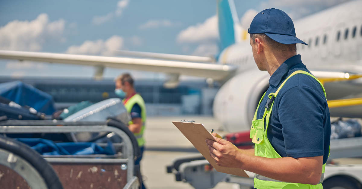 Ground handler searching Ground handler searching for a missing baggage dolly on an airport ramp