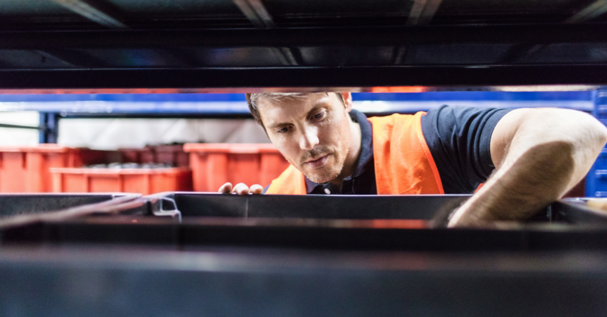 Image Warehouse worker looking for equipment that is supposed to be in the rack