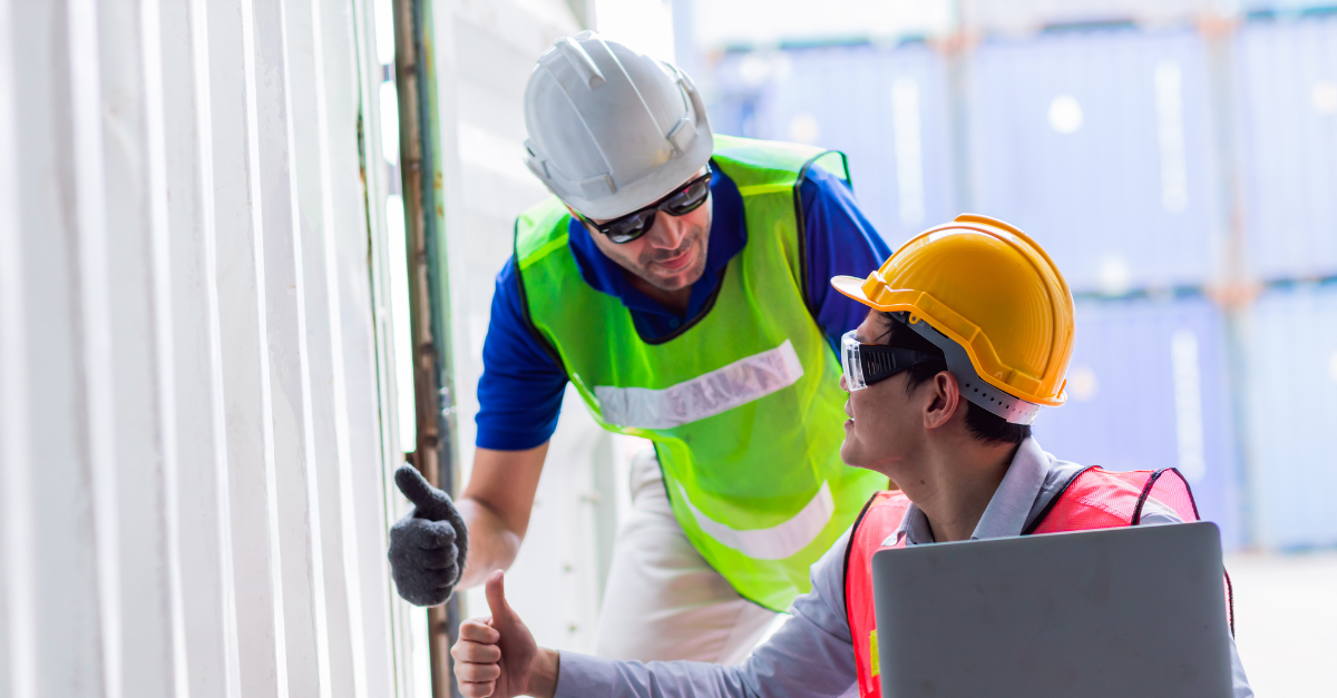 Two men in the logistics site doing thumbs up looking at each other after checking their assets